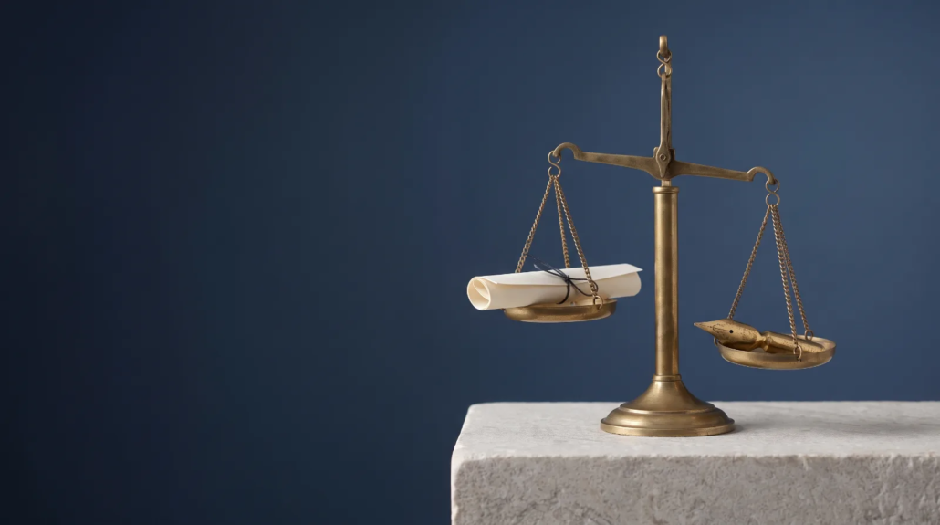 Balance scale with a document and a pen nib