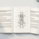 Patent specification pages and technical drawings laid out on a desk for Arabic translation